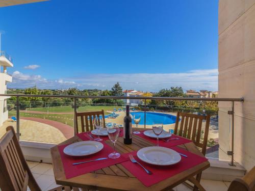 a table with a wine bottle and glasses on a balcony at Apartment Monte da Eira by Interhome in Brejos
