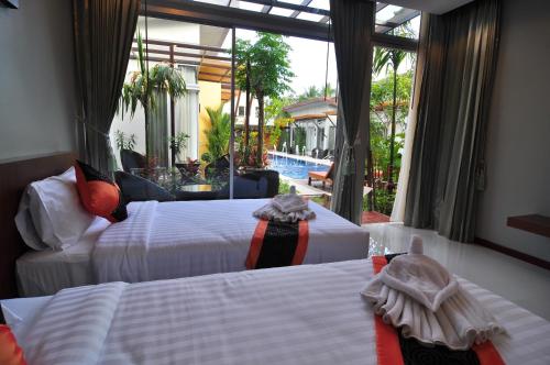מיטה או מיטות בחדר ב-Phu NaNa Boutique Hotel - SHA Plus