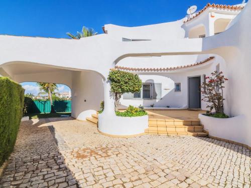 a white house with a courtyard and a driveway at Villa Arribas Villa by Interhome in Patroves