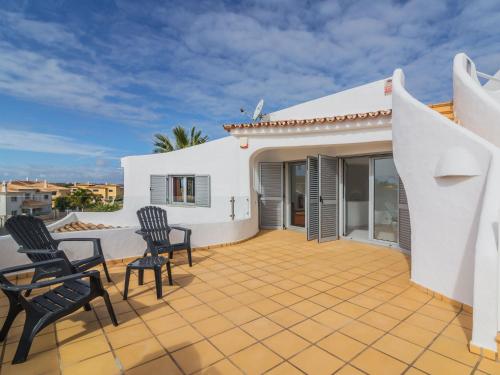 a patio with chairs and a white house at Villa Arribas Villa by Interhome in Patroves
