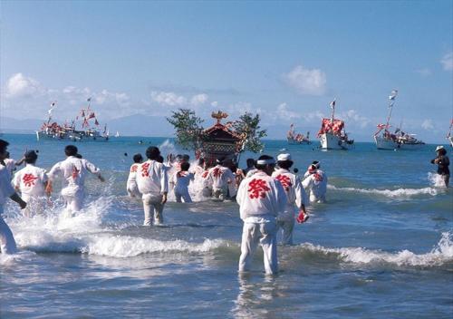 a group of people in the water with boats at APA Hotel Miyazaki Eki Tachibanadori in Miyazaki
