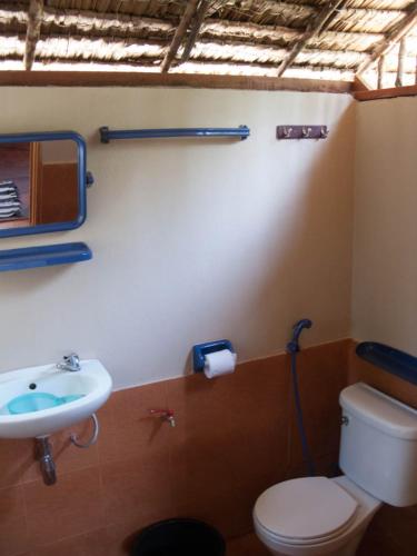 a bathroom with a toilet and a sink at SiBoya Bungalows in Siboya