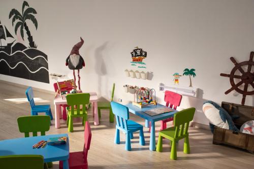 a room with colorful chairs and a table and a dining room at Hyde Park Lane in Puerto del Carmen