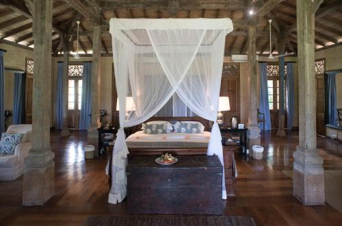 a bedroom with a bed with a canopy at Kahanda Kanda in Koggala