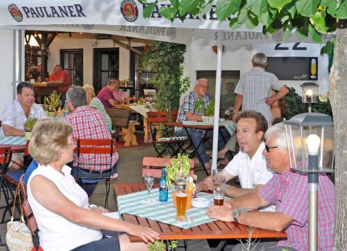 a group of people sitting at a table in a restaurant at Hotel Lindenhof in Rödermark