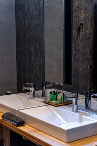 a bathroom sink with a large mirror above it at Design Hotel 36 in Sofia