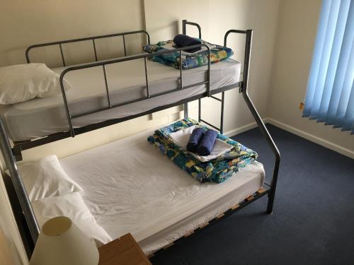 two bunk beds with towels on them in a room at Koonwarra Holiday Park in Lakes Entrance