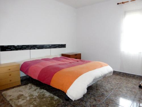 a bedroom with a bed with a colorful blanket at Nice double room in Alicante in Alicante
