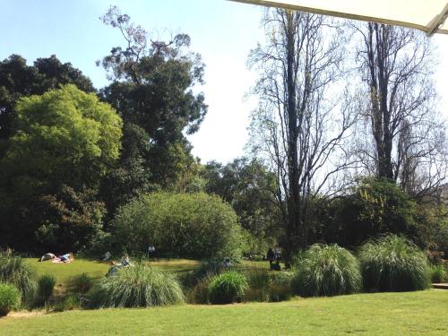 a park with people sitting in the grass at HI71 Lisboa in Lisbon