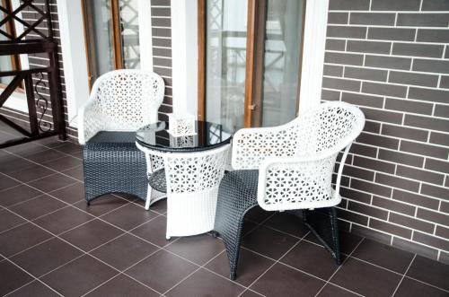 two chairs and a table on a patio at Luxury House in Shymkent