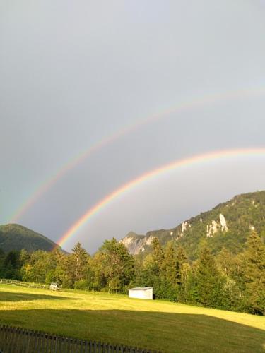 a rainbow in the sky over a field at Haus Salvenmoser in Walchsee