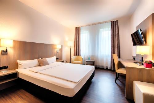 Postel nebo postele na pokoji v ubytování ACHAT Hotel Bochum Dortmund