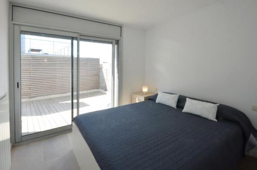 a bedroom with a large bed and a large window at Bellavista - Ref. 029 in Begur