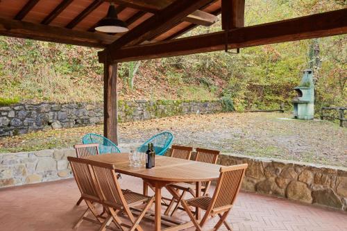 a wooden table and chairs on a patio at Fattorie di Celli in Poppi