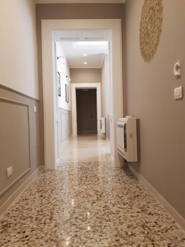 a hallway with a tile floor in a house at MammaDada charm rooms in Bari