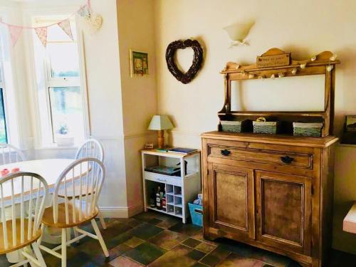 a room with a mirror and a table and chairs at Birch Tree Cottage in Westport