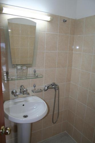 a bathroom with a sink and a mirror at Oasis Villas in Golden Sands