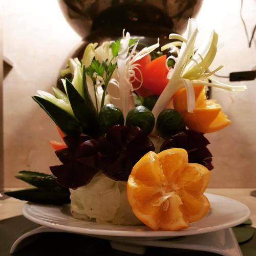 a plate of food with oranges and vegetables on it at Dellarosa Boutique Hotel and Spa in Marrakech