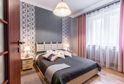 1 dormitorio con cama y ventana grande en Apartament Bulwary Zakopane, en Zakopane