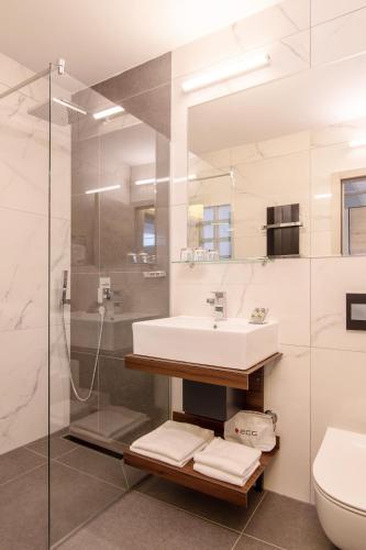 a bathroom with a sink and a shower at Dependences - San Simon Resort in Izola