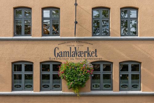 a building with a potted plant on the facade at GamlaVaerket Hotel in Sandnes