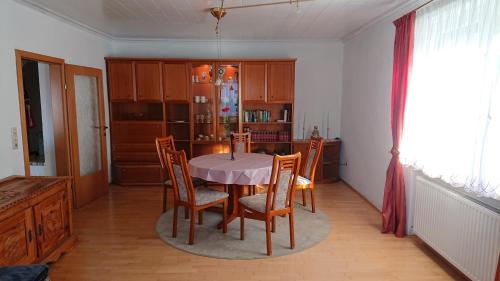 a kitchen with a table and chairs in a room at Haus Danklmaier in Öblarn