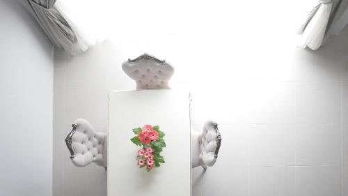 a bathroom with a mirror with a flower on it at Zetter Suites @ Cameron in Cameron Highlands