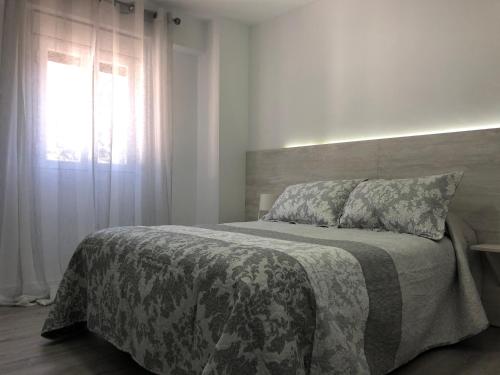Postel nebo postele na pokoji v ubytování APARTAMENTOS CAZORLA CENTRO