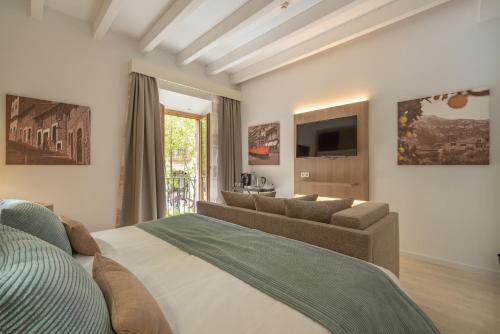 a bedroom with a large bed and a couch at Soller Plaza in Sóller