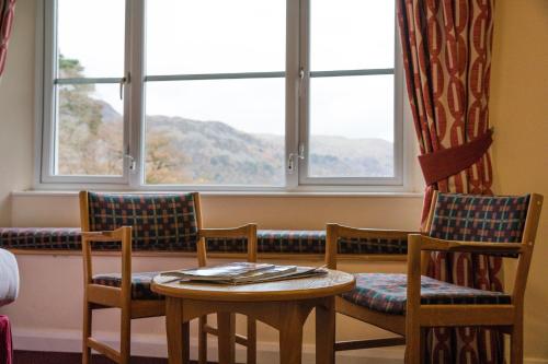 
two chairs and a table in a room at Patterdale Hotel in Patterdale
