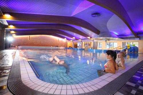 a large swimming pool with people in it at Design Hotel Levi in Levi