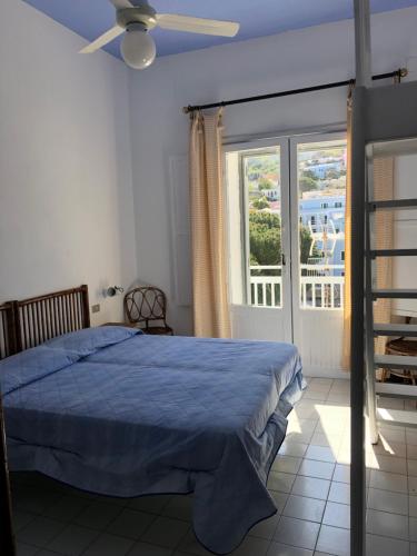 a bedroom with a blue bed and a window at VisitPonza - Palazzetto Azzurro in Ponza