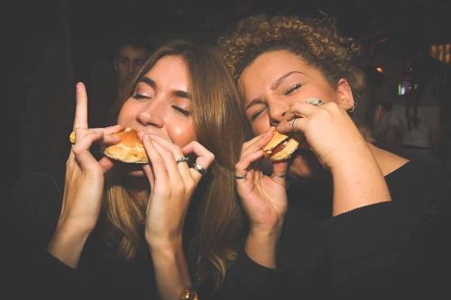 two women are eating food with their hands at St Christopher's Inn London Bridge - Oasis Female Only in London