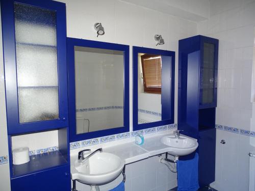 a bathroom with two sinks and two mirrors at villa Marija in Ohrid