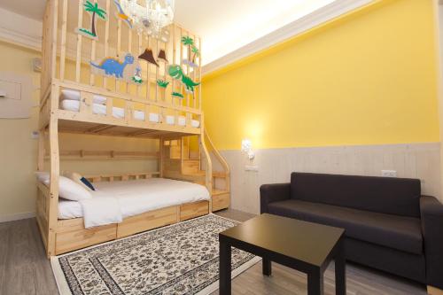 a living room with a bunk bed and a couch at 歐拉民宿 l 大空間包棟 l 親子溜滑梯 l 專業音響 in Taitung City