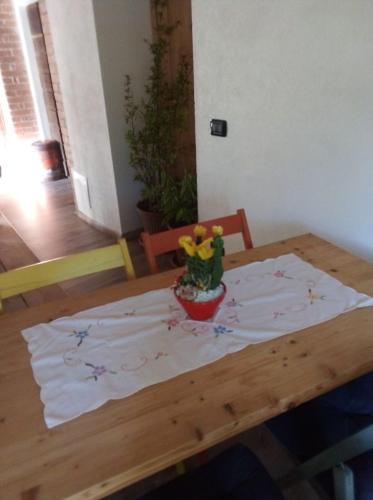 a wooden table with a flower vase on top of it at YHouse 33 in Trento
