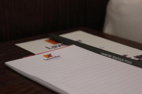 two envelopes sitting on top of a wooden table at Lavender Boutique Hotel in Ramallah