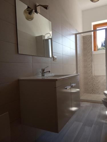 a bathroom with a sink and a mirror at Le dimore di Flora Charme in Monopoli