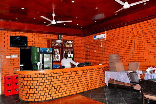 a man standing at the counter of a restaurant at Quality Hotel Juba in Juba