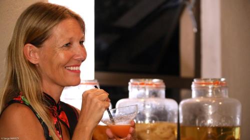 a woman sitting at a table with a drink at Lindiwe Safari Lodge in Hoedspruit