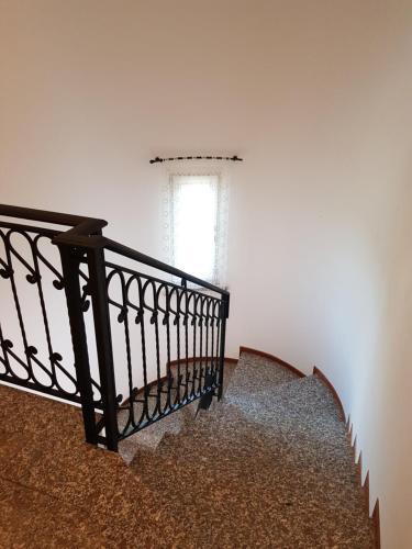 a stairway with a black railing and a window at B&B Villa Giulia in Desenzano del Garda