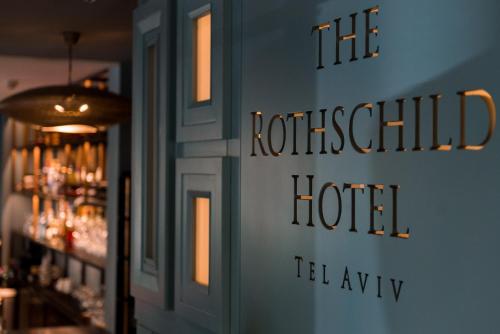 a sign on the wall of a room with a bar at The Rothschild Hotel - Tel Aviv's Finest in Tel Aviv