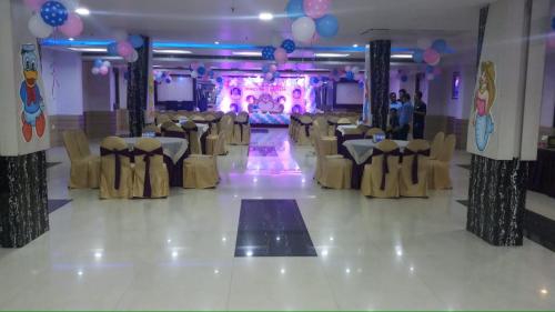 a banquet hall with chairs and a dance floor at The Kannelite in Jamshedpur
