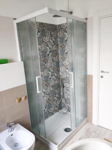 a shower in a bathroom with a toilet and a sink at B&B De Angelis in Ginosa Marina