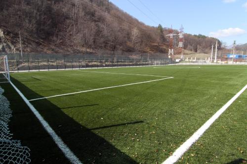 an empty soccer field with a soccer goal at Hotel Class in Brezoi