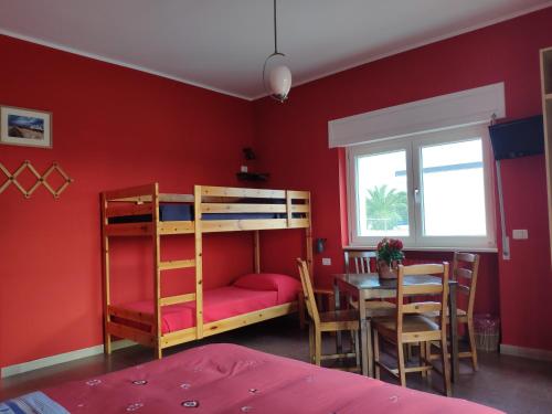 a bedroom with a bunk bed and a table at B&B De Angelis in Ginosa Marina