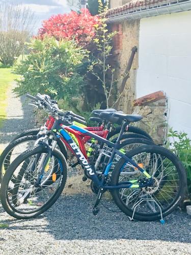 two bikes are parked next to a house at La Blatière French Cottages in La Chapelle-Saint-Étienne