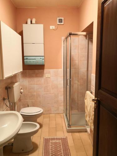 a bathroom with a shower and a toilet and a sink at San Giovannina '800 in Casale Monferrato