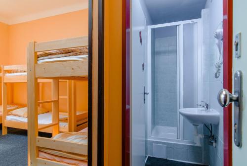 a small room with a bunk bed and a toilet at Best Spot Hostel in Prague