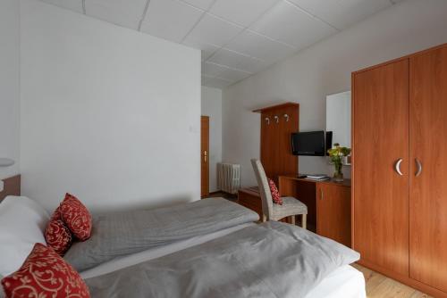 a bedroom with a bed and a cabinet and a tv at Hotel Pejo in Peio Fonti